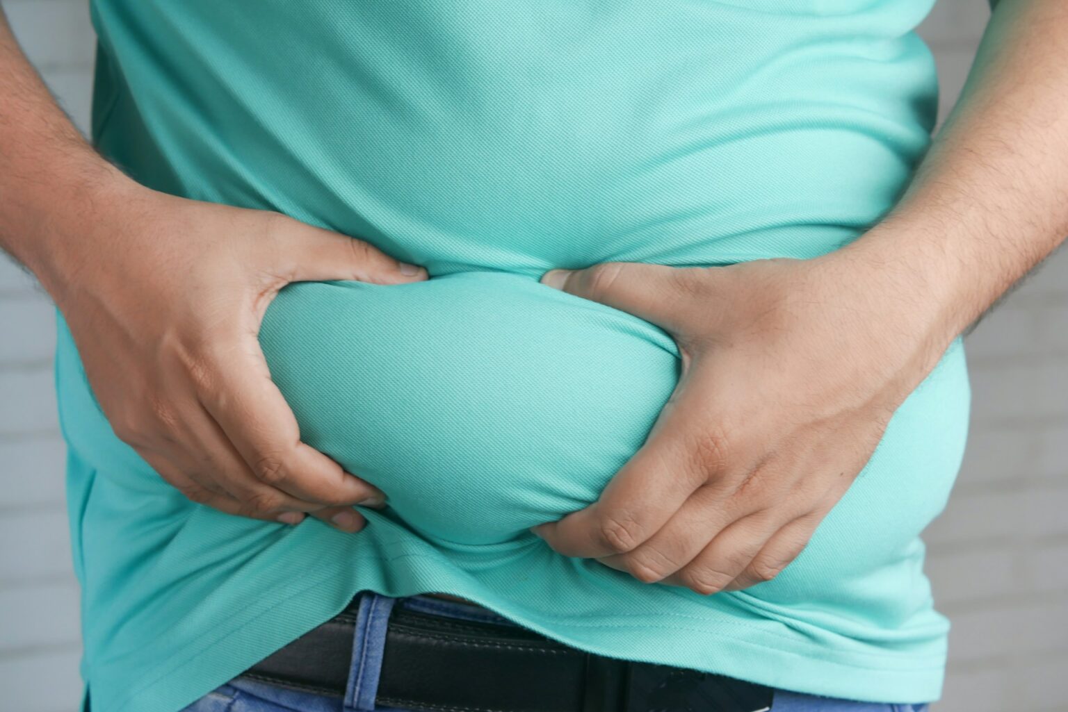 1778073169 man with excessive fat in lower abdomen to show example of a common treatment area for stomach liposuction 1536x1025